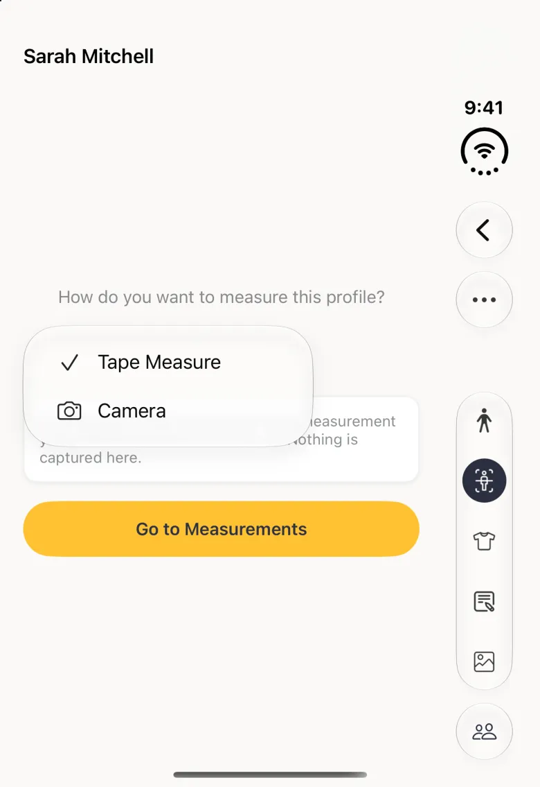Body Scan section of Sarah Mitchell's profile on the closed Duo, titled with her name, with an open menu under How do you want to measure this profile? listing Tape Measure with a tick and Camera with a camera icon, above a gold Go to Measurements button; the vertical bar strip on the right holds Back and a round more button near the top, the five section buttons with Body Scan selected, and a round Clients button at its foot.
