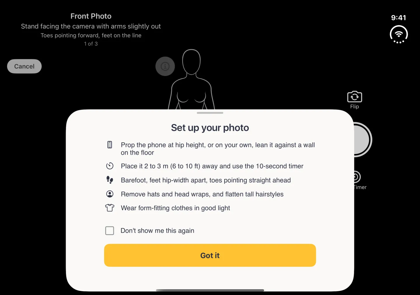 A Set up your photo sheet with a grabber, centred over the lower half of the full-screen black camera in landscape on the open Duo, listing five tips with small icons (prop the phone at hip height or lean it on a wall, stand 2 to 3 metres away and use the 10-second timer, barefoot with feet hip-width apart and toes straight ahead, remove hats and flatten tall hairstyles, wear form-fitting clothes in good light), an unticked Don't show me this again checkbox and a gold Got it button; above it the Front Photo banner reading 1 of 3, Cancel at the left, the dimmed info button and the head of the line-art body guide, with Flip, the shutter and 10s Timer partly behind the sheet at the right and 9:41 and Wi-Fi in the strip on the right edge.