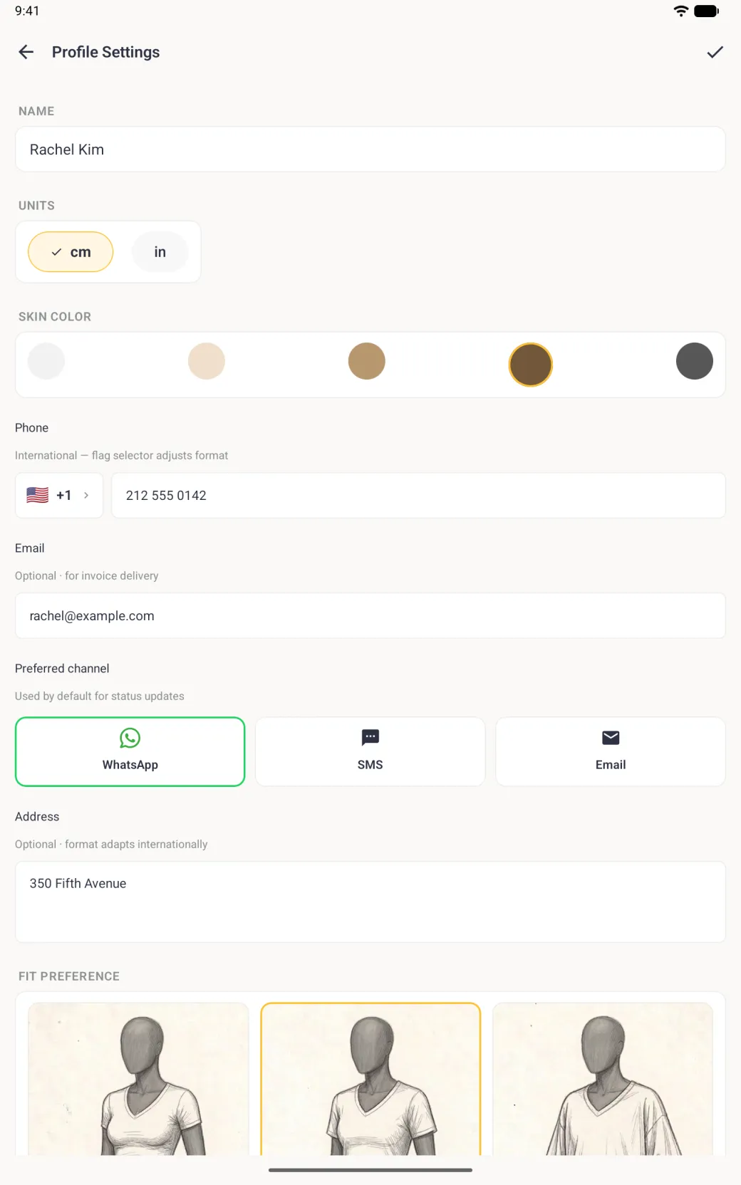 Profile Settings screen with the name Rachel Kim, cm selected, a brown skin tone ringed in gold, the phone 212 555 0142, the email rachel@example.com, WhatsApp outlined as the preferred channel, the address 350 Fifth Avenue and the top of the fit preference sketches with Regular outlined in gold.