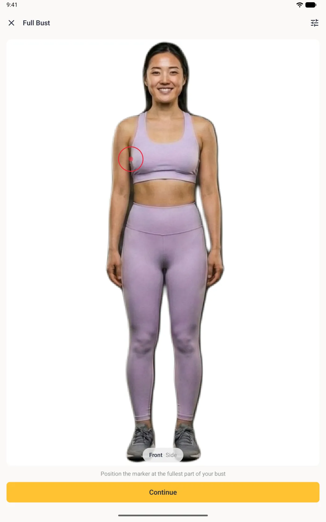 A front scan photo of a woman in a lilac sports top and leggings filling a white card, with a red target circle at the left side of her bust, a Front · Side pill at the foot of the photo, the instruction Position the marker at the fullest part of your bust and a yellow Continue button.