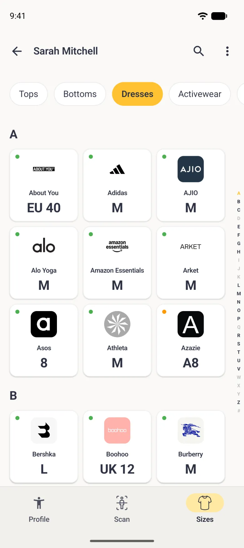 A Sizes tab on Dresses in a three-column grid of brand logo cards grouped under the heading A, About You, Adidas, AJIO, Alo Yoga, Amazon Essentials and Anthropologie, each with a green dot and a size, with a full A to Z alphabet index running down the right edge.