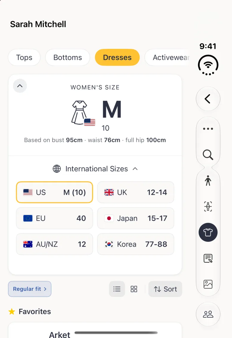 An expanded Dresses size card on the closed Duo listing US M (10) outlined in gold, UK 12-14, EU 40, Japan 15-17, AU/NZ 12 and Korea 77-88 in two columns of flag tiles under the International Sizes row, above the Regular fit pill and the Favorites heading.