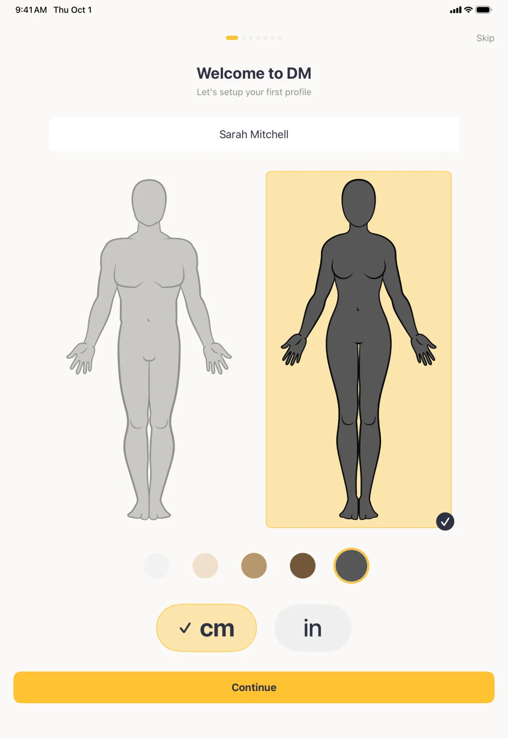 Welcome screen with the charcoal skin tone ringed in gold, the selected woman outline filled in that tone beside a greyed man outline, the cm button ticked, and a gold Continue button across the foot of the screen.