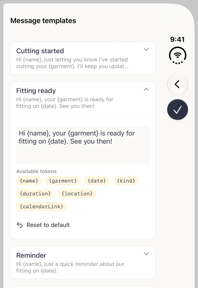 Expanded Fitting ready card on the closed iPhone Duo with an editable text box reading Hi {name}, your {garment} is ready for fitting on {date}. See you then., seven pale gold token chips under Available tokens labelled {name}, {garment}, {date}, {kind}, {duration}, {location} and {calendarLink} wrapping over three rows, and a Reset to default link with a back-arrow icon; the back and round checkmark buttons sit in the vertical bar strip on the right edge.