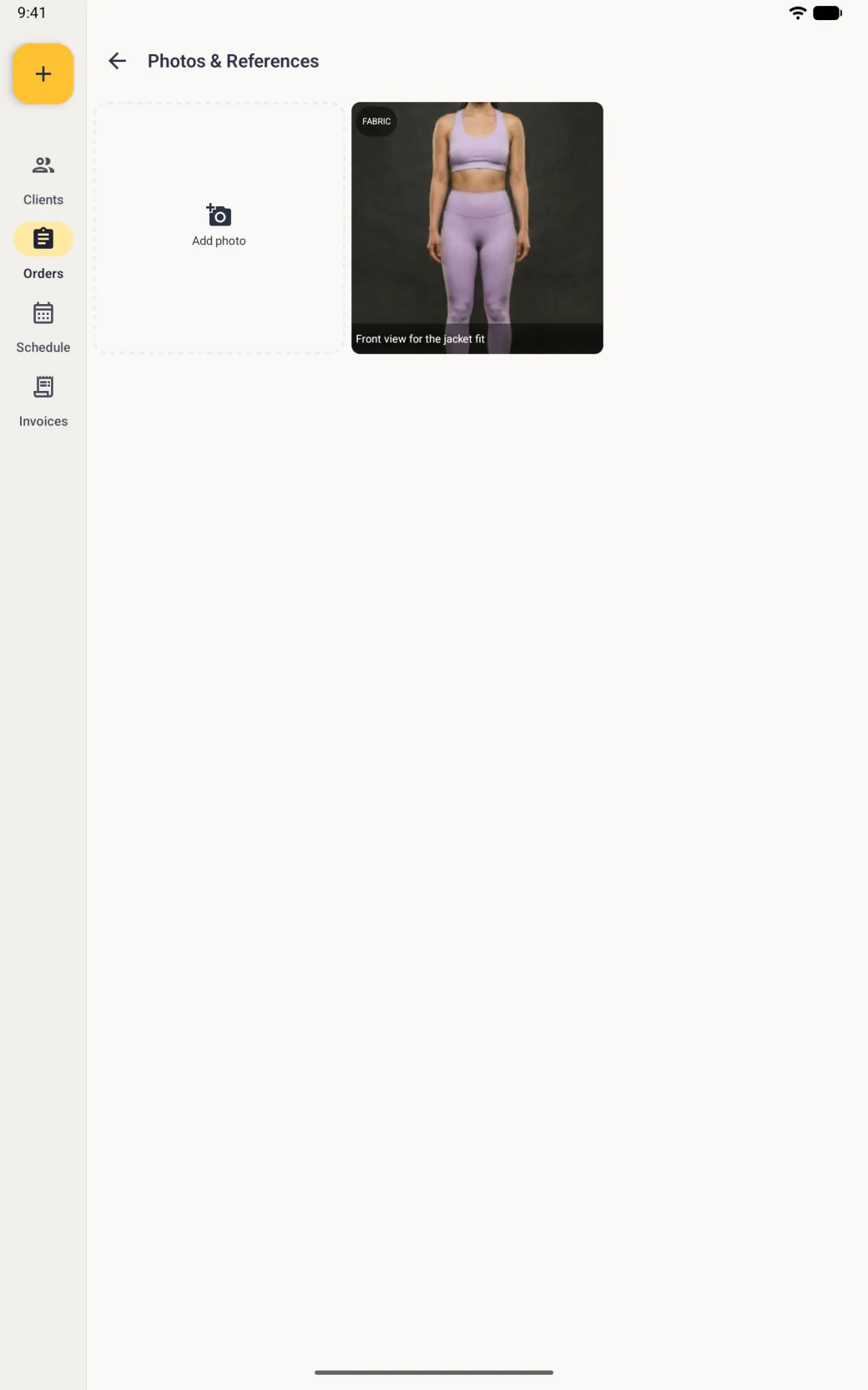 Photos and References screen beside the navigation rail with a dashed Add photo tile and the new photo, a front-facing body photo tagged FABRIC with the caption Front view for the jacket fit along its foot.
