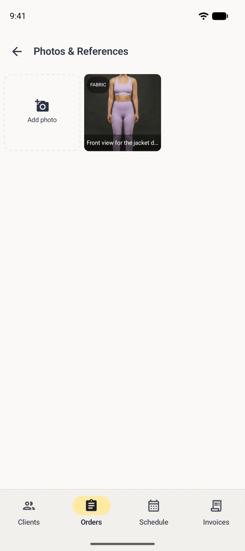 Photos and References grid with a dashed Add photo tile and one photo of a body from the front, tagged Fabric at the top left and captioned Front view for the jacket drape along the bottom.