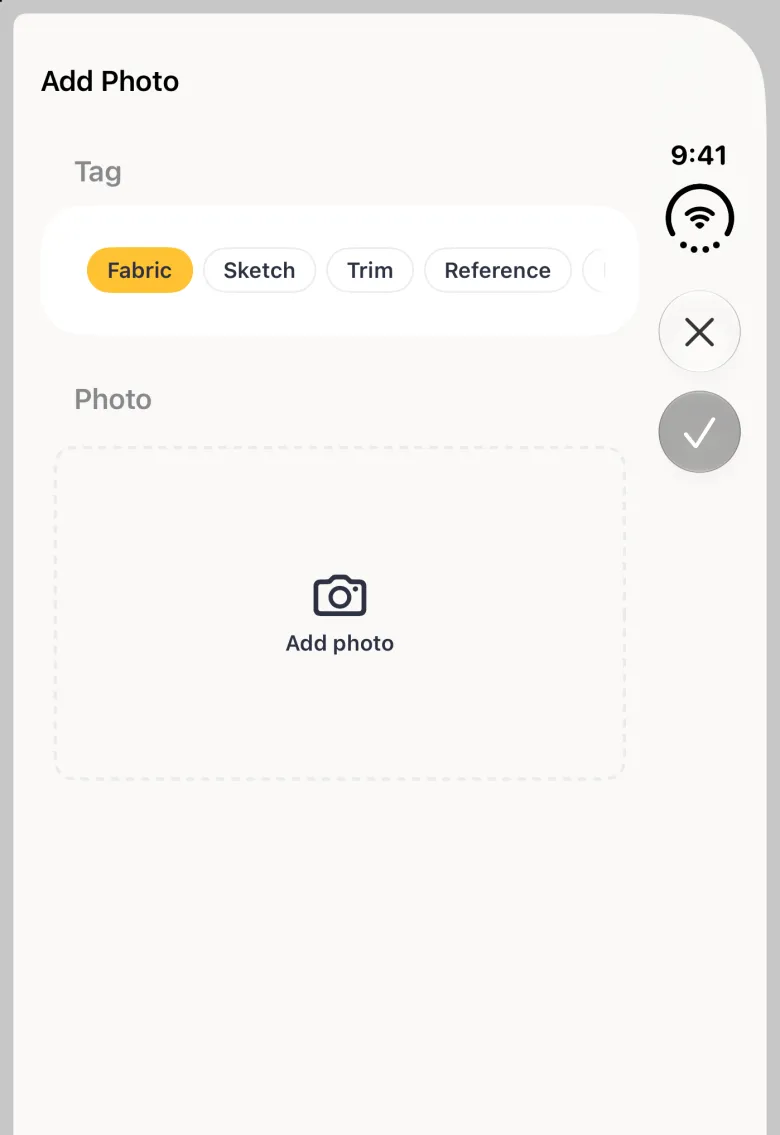 Add Photo sheet on the closed iPhone Duo with a close button and a dimmed round tick stacked in the vertical bar strip on the right edge, tag chips reading Fabric, Sketch, Trim and Reference (Fitting scrolled off the right edge of the row) with Fabric selected in gold, and an empty dashed Add photo area with a camera icon.