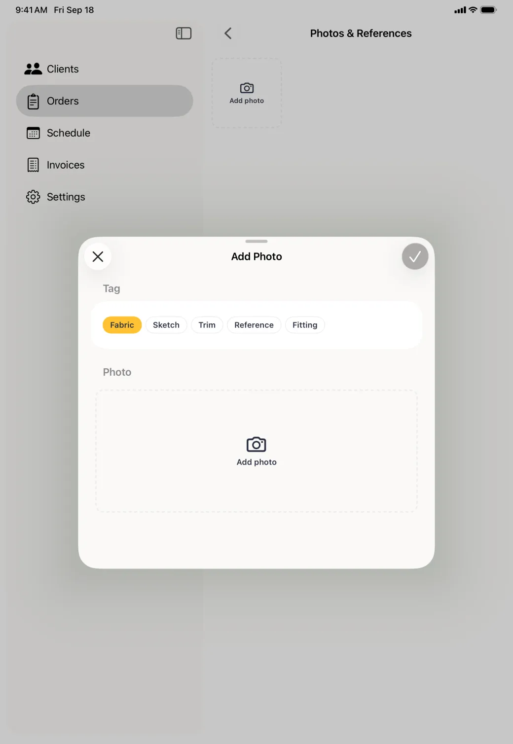 Add Photo card centred over the dimmed Photos and References pane, with tag chips reading Fabric, Sketch, Trim, Reference and Fitting, and Fabric selected in gold.