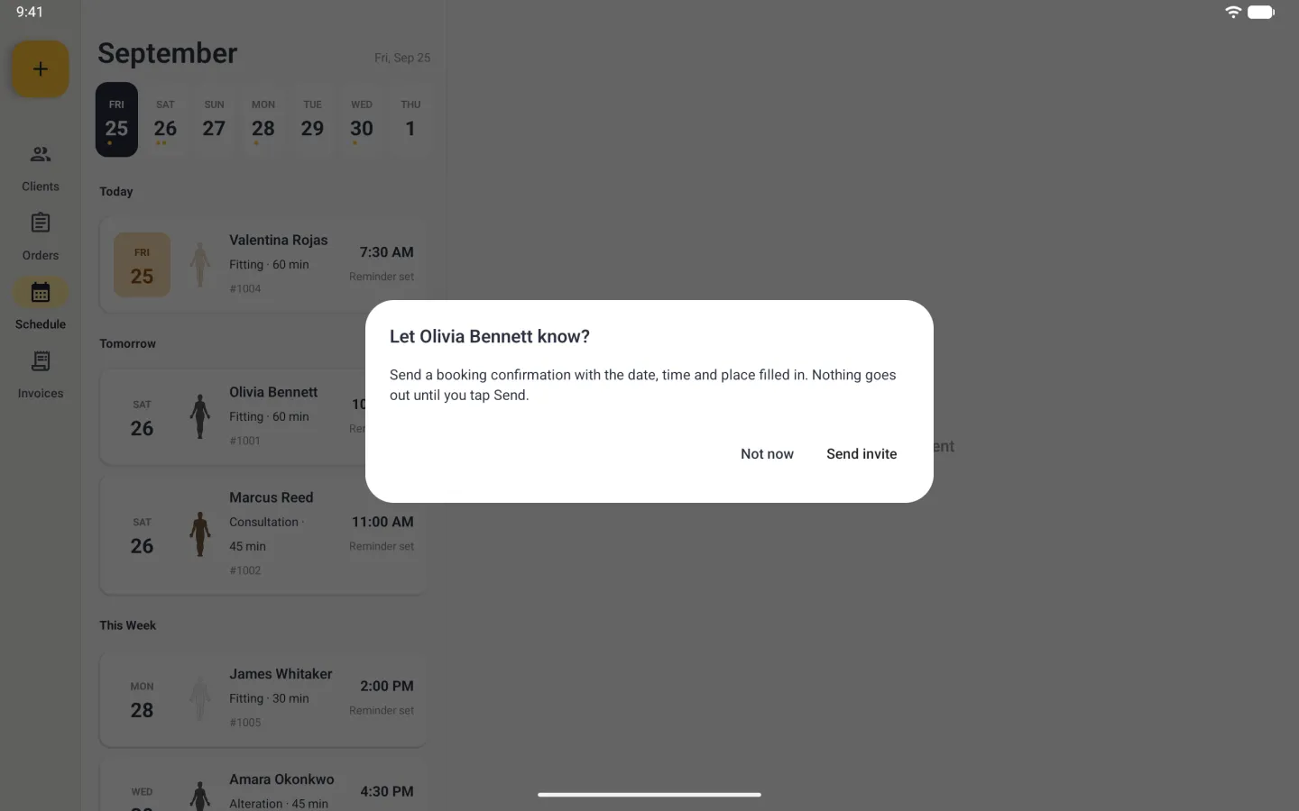 Centred white dialog over the dimmed Schedule reading Let Olivia Bennett know? with the line send a booking confirmation with the date, time and place filled in, nothing goes out until you tap Send, and two text buttons, Not now and Send invite. Behind the dim, Olivia Bennett's new fitting already sits first under Tomorrow.