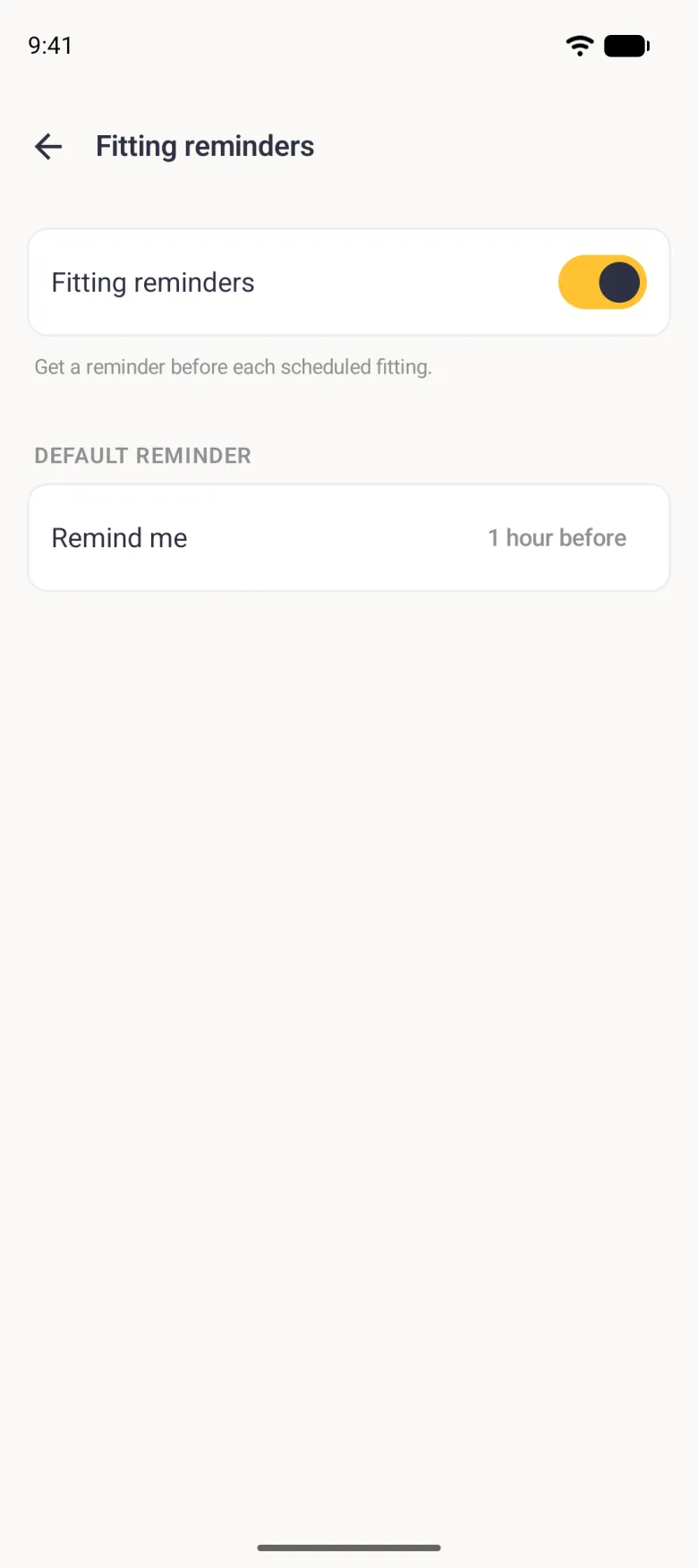 Fitting reminders screen with the Fitting reminders switch on in gold, the note Get a reminder before each scheduled fitting, and a Default reminder row reading Remind me, 1 hour before.